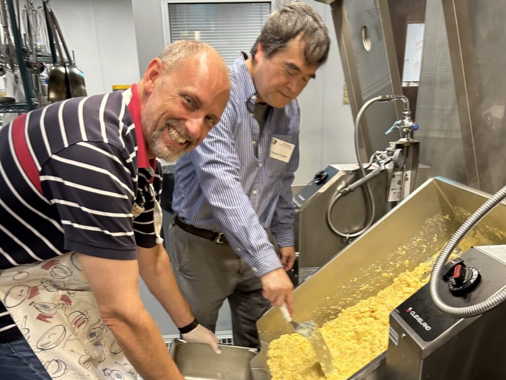 Volunteers cooking together to serve neighbors in need