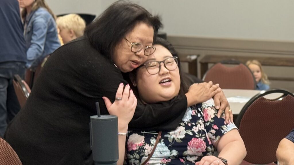 Two women sharing a warm hug at Harrison